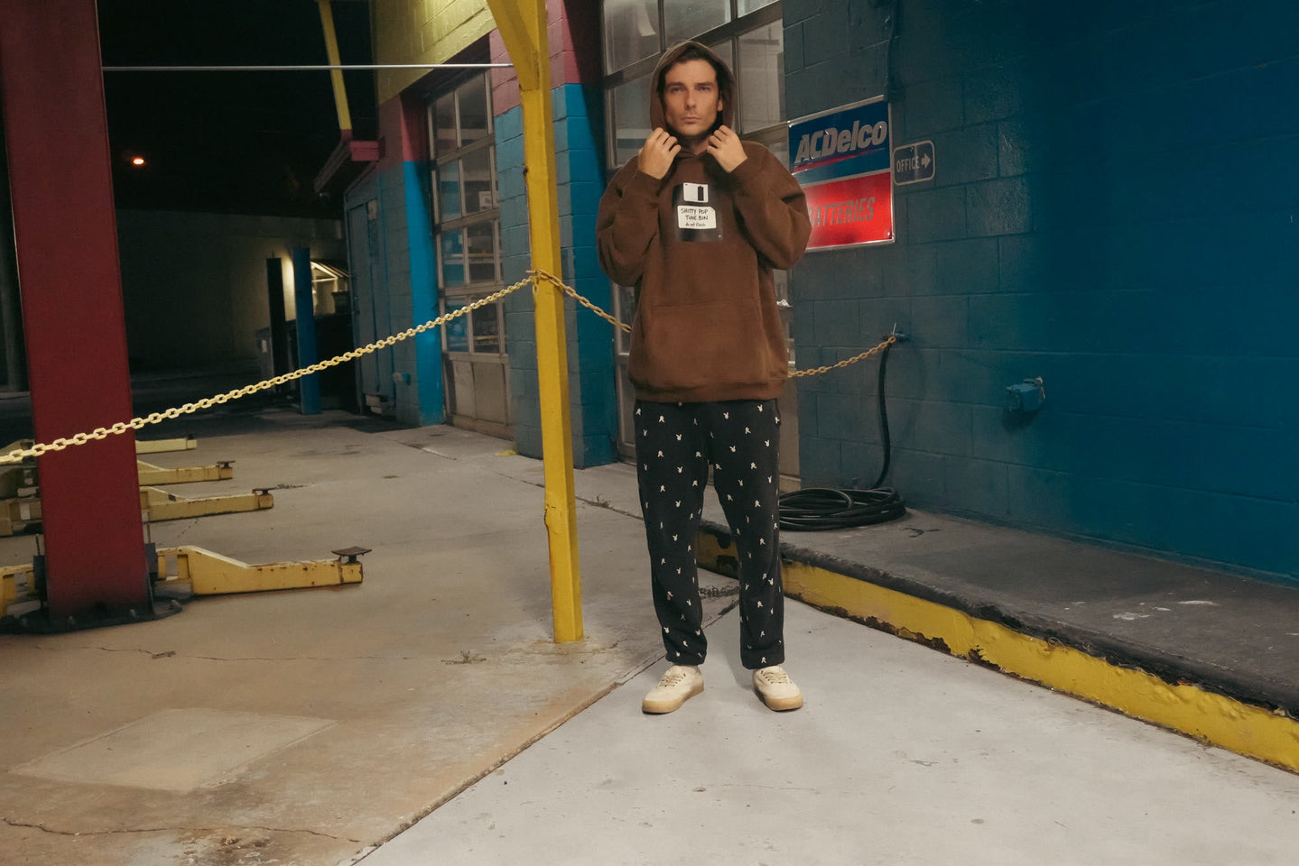 Shitty Pop Tune hoodie - lifestyle angle 2, night garage